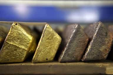 Gold steadies as dollar dip offsets pressure from hawkish Fed